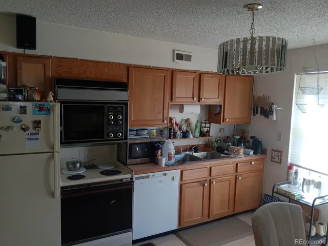 a kitchen with stainless steel appliances a sink stove and cabinets