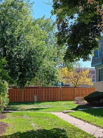 a view of a yard with wooden fence