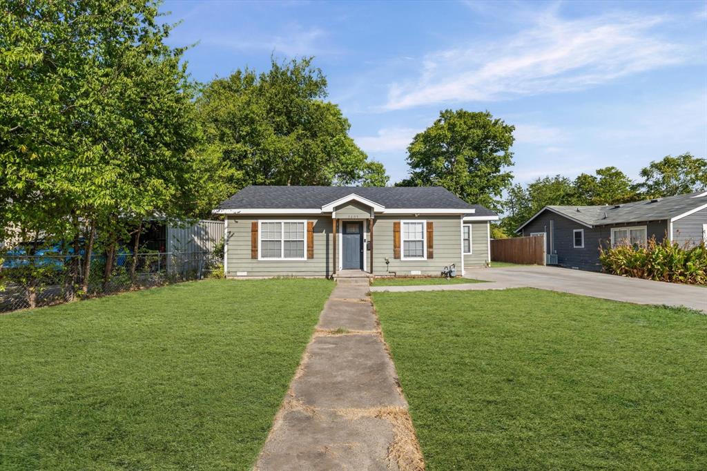 3605 Rolando Avenue Waco, TX 76711 - Photo 1 of 17 Single-story residence featuring light gray siding with white trim, dark roof, and a front entry with a dark door and side panels
