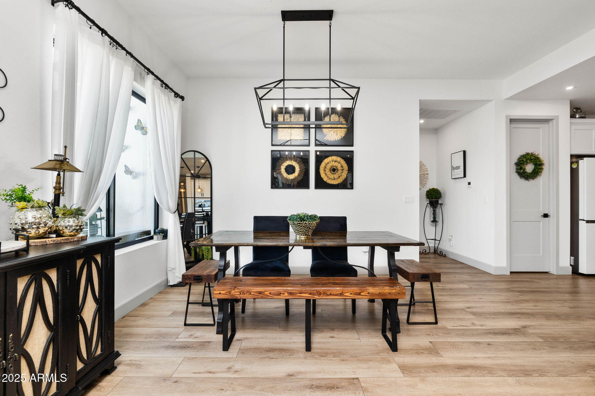 4876 North Yorkshire Loop Prescott Valley, AZ 86314 - Photo 12 of 47 a dining room with wooden floor a chandelier a wooden table and chairs