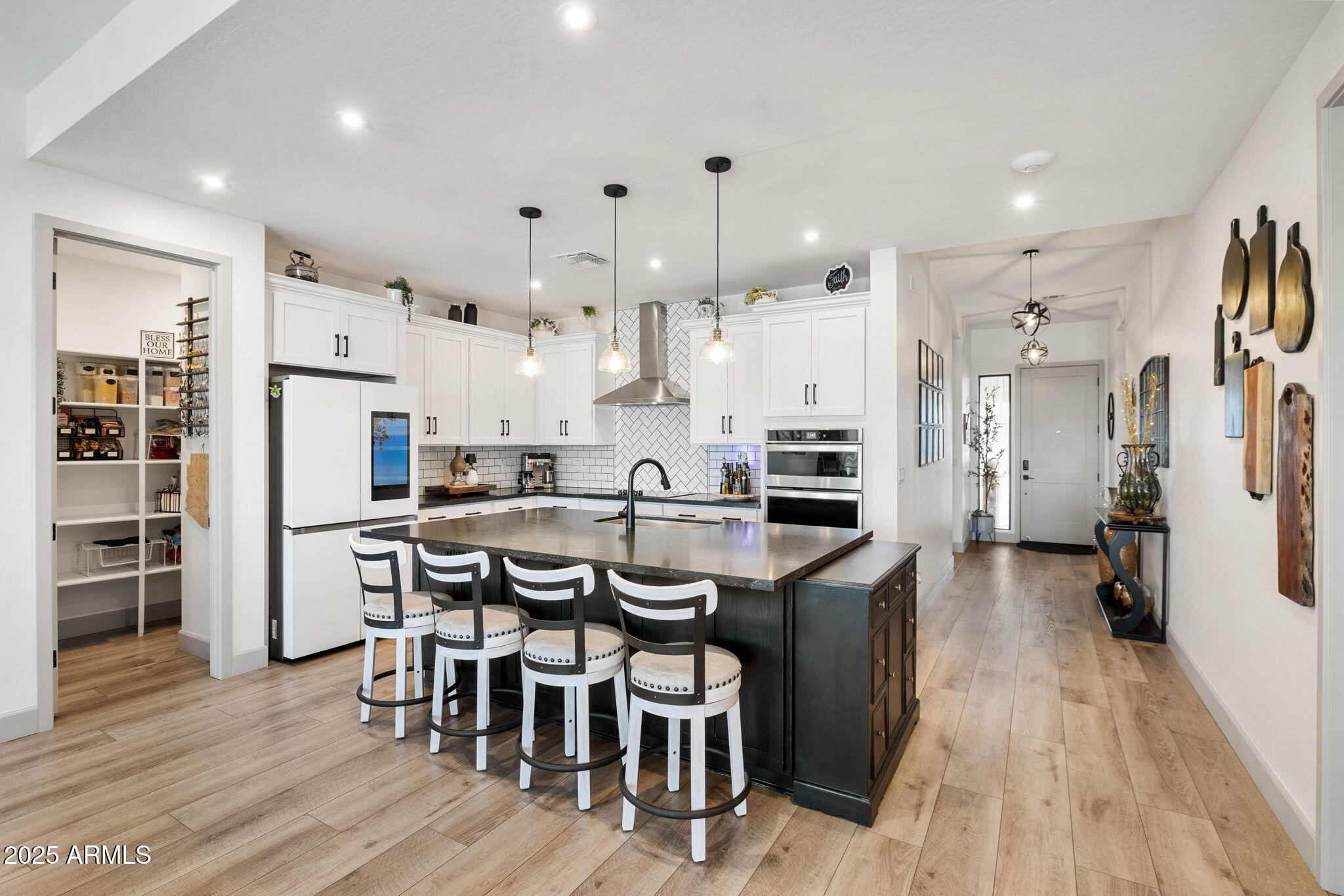 4876 North Yorkshire Loop Prescott Valley, AZ 86314 - Photo 16 of 47 a kitchen with stainless steel appliances a refrigerator a stove top oven a sink dishwasher and white cabinets with wooden floor