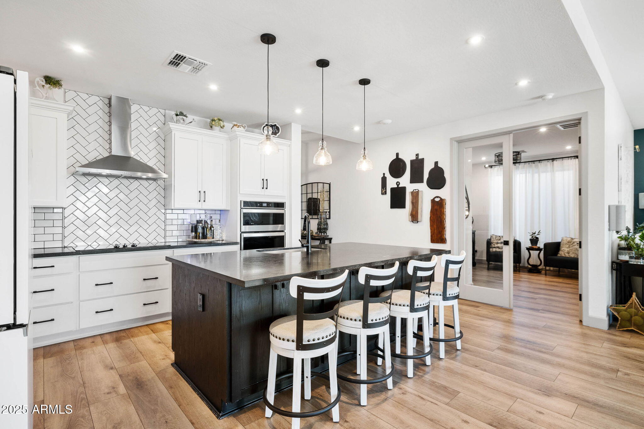 4876 North Yorkshire Loop Prescott Valley, AZ 86314 - Photo 17 of 47 a kitchen with stainless steel appliances kitchen island granite countertop a table chairs sink and cabinets