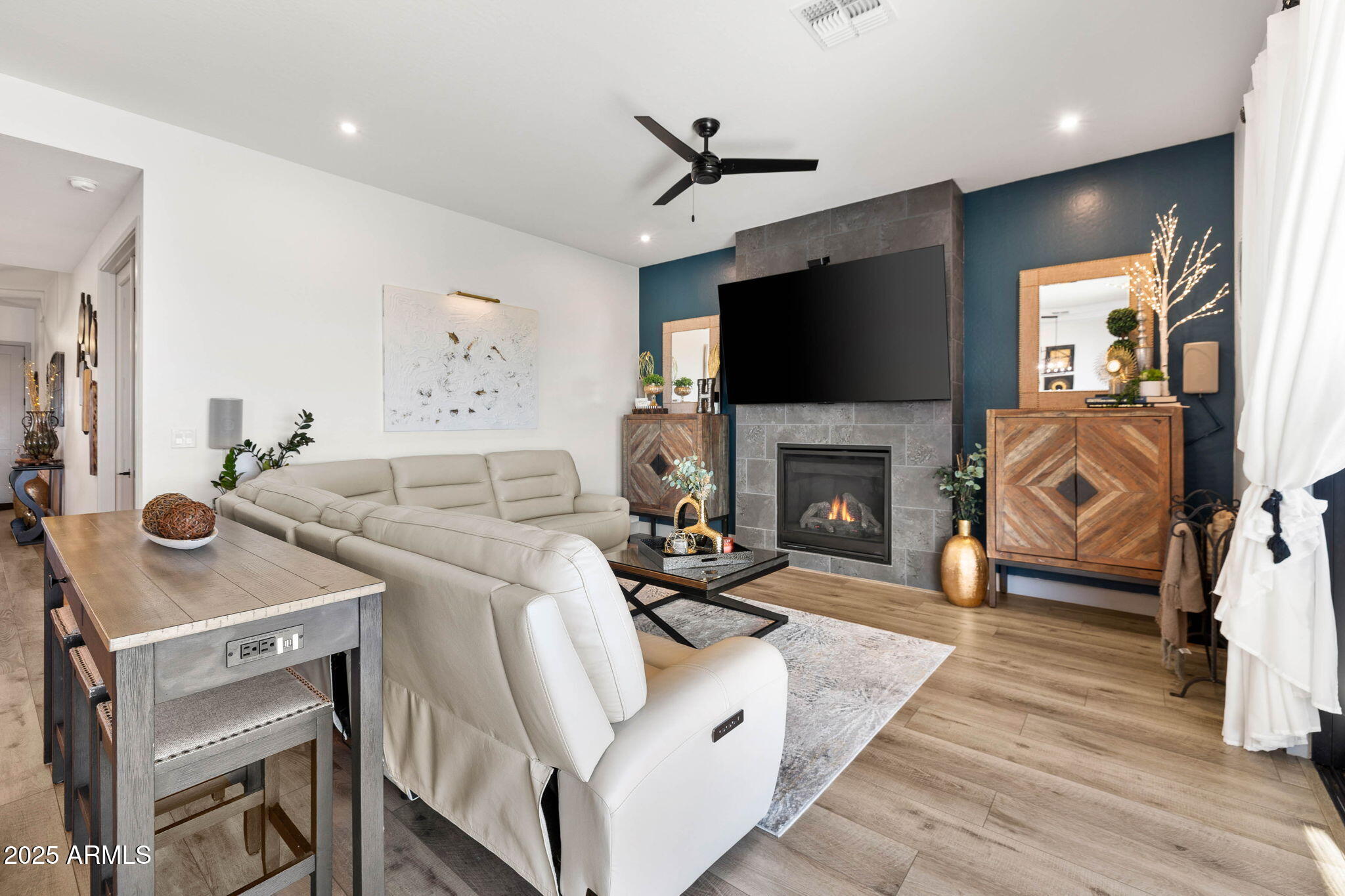 4876 North Yorkshire Loop Prescott Valley, AZ 86314 - Photo 9 of 47 a living room with furniture a flat screen tv and a fireplace