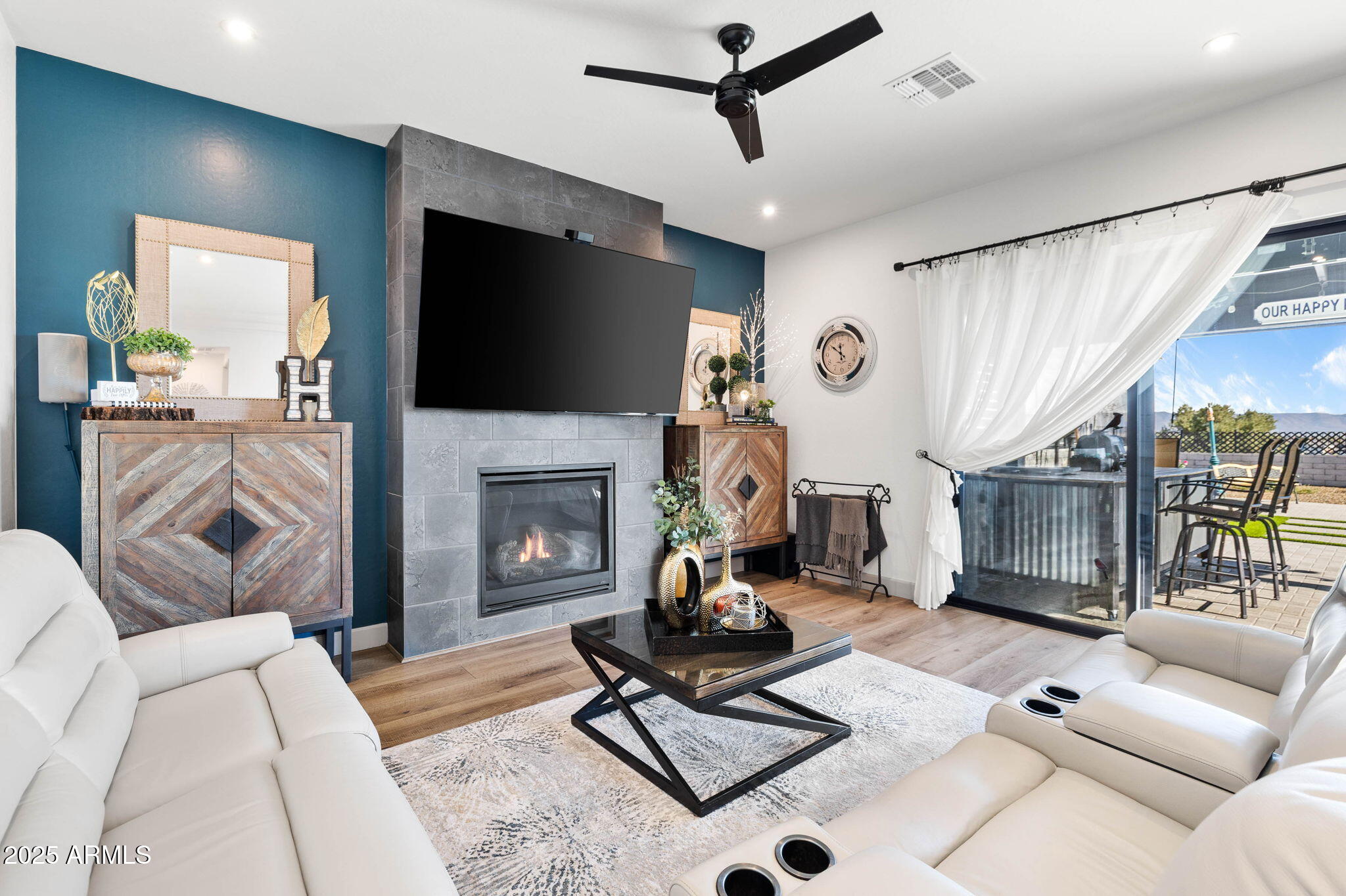 4876 North Yorkshire Loop Prescott Valley, AZ 86314 - Photo 10 of 47 a living room with furniture a flat screen tv and a fireplace
