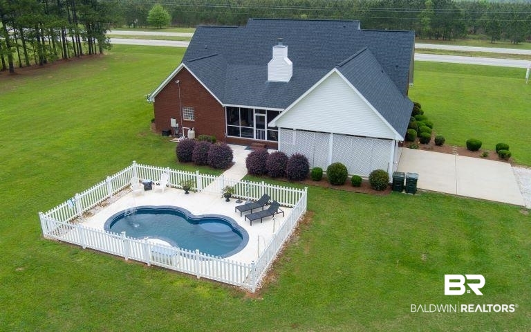 24541 Baldwin Beach Expressway Robertsdale, AL 36567 - Photo 48 of 51 View of swimming pool with a fenced backyard, a fenced in pool, a patio area, and a lawn