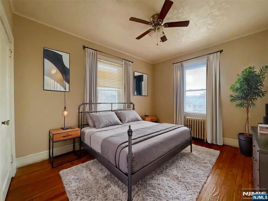 a bedroom with a bed and a potted plant