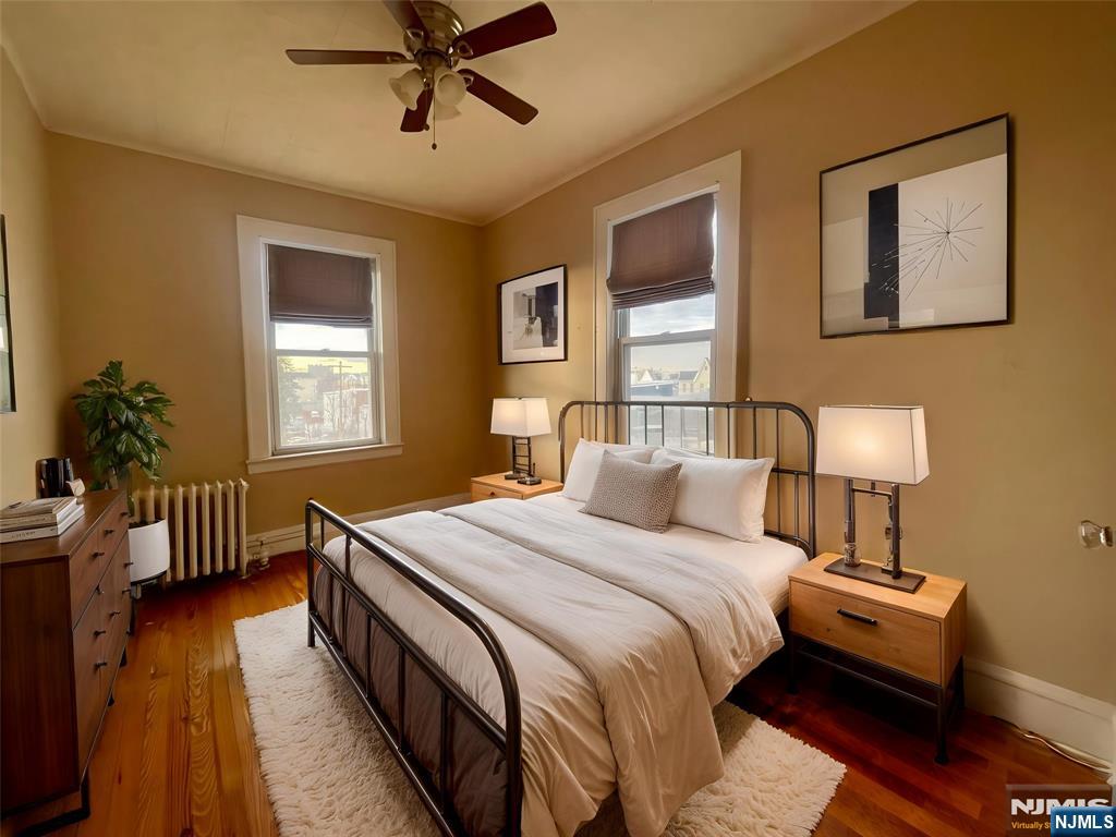 145 Maple Street, Unit 2 Kearny, NJ 07032 - Photo 3 of 3 a bedroom with a bed and wooden floor