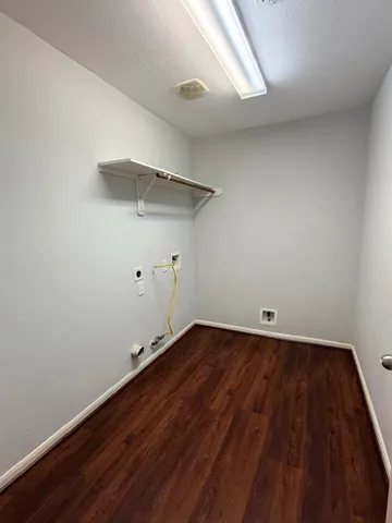 a view of a room with wooden floor and white walls
