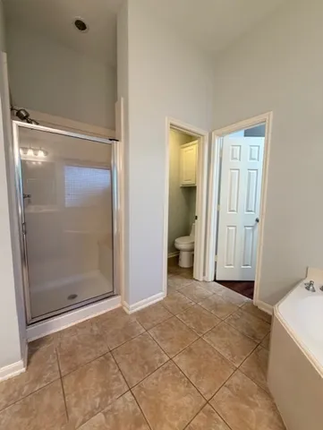 a view of a bathroom with a tub and shower