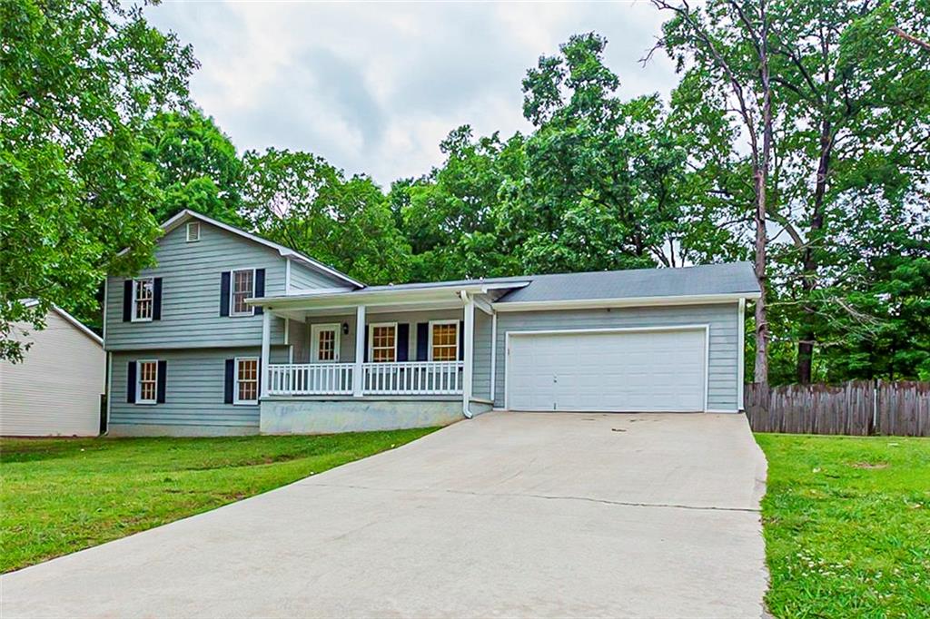 a front view of house with yard and green space