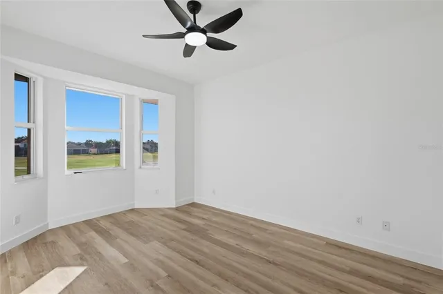 wooden floor in an empty room with a window