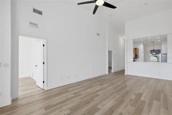 a view of a room with wooden floor staircase and a sink