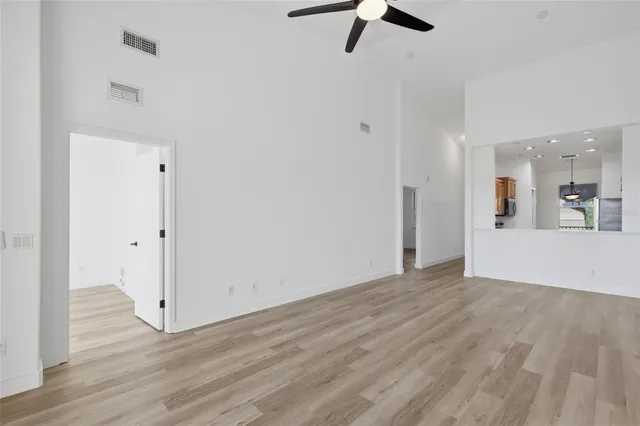 a view of a room with wooden floor staircase and a sink