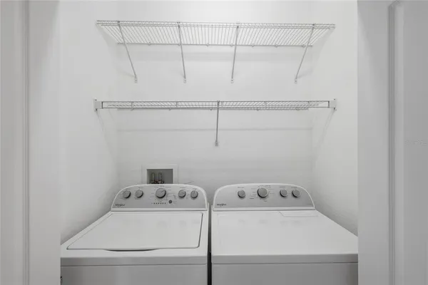 an empty room with a window and ceiling fan