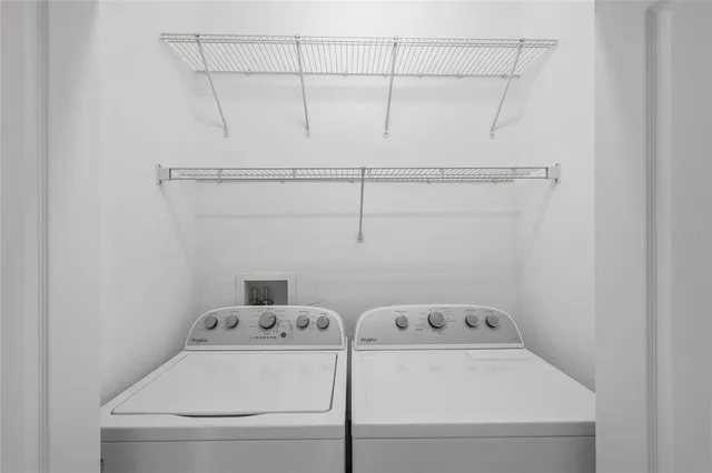 an empty room with a window and ceiling fan