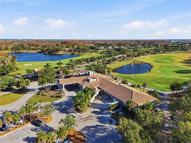 an aerial view of residential houses with outdoor space and swimming pool