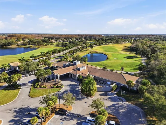an aerial view of residential houses with outdoor space and ocean view