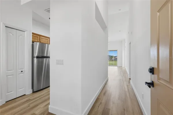 a view of a room with wooden floor and white doors