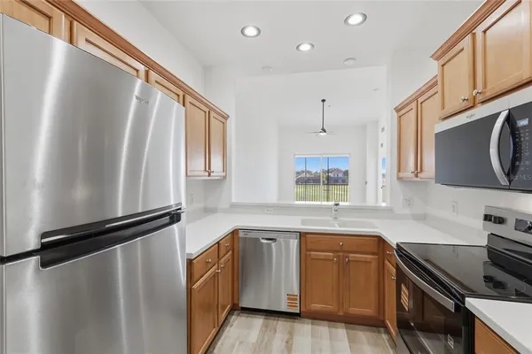 a kitchen with stainless steel appliances a stove microwave and sink