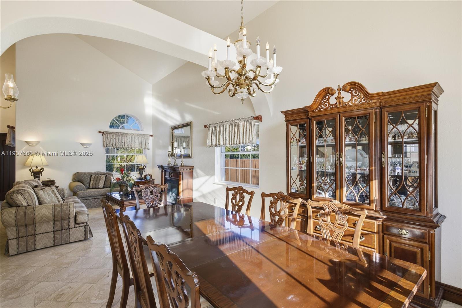 20816 Southwest 85th Place Cutler Bay, FL 33189 - Photo 15 of 49 a view of a dining room with furniture a chandelier and wooden floor