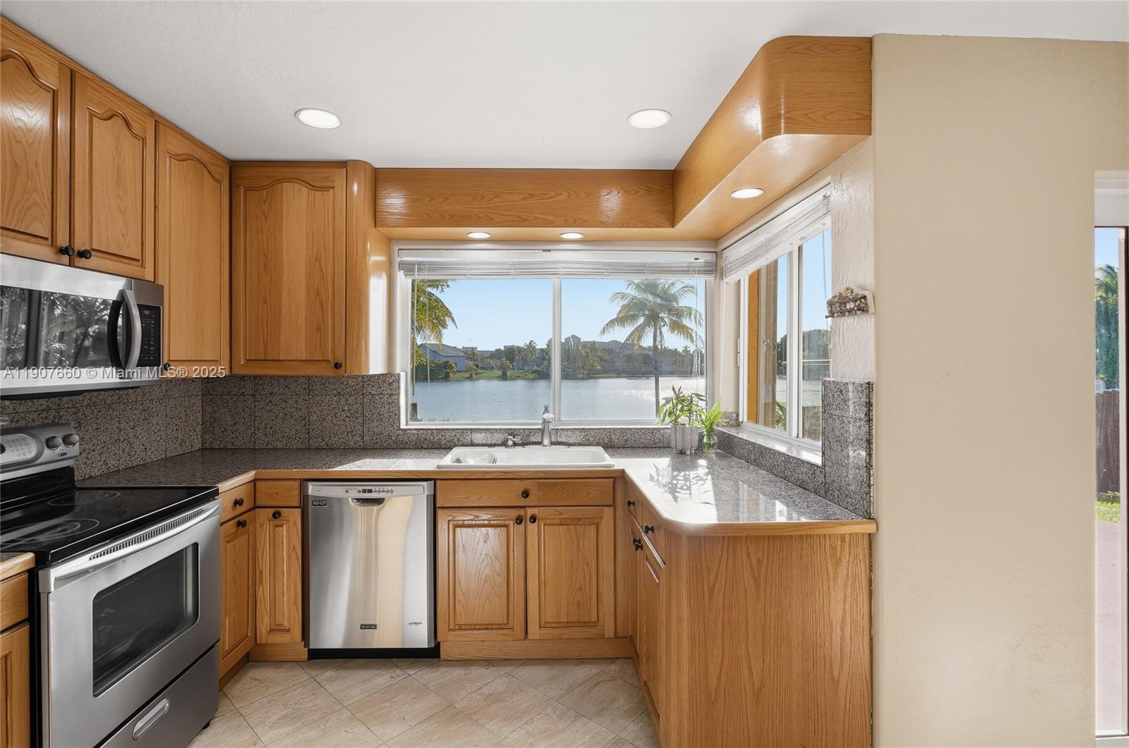 20816 Southwest 85th Place Cutler Bay, FL 33189 - Photo 19 of 49 a kitchen with a sink and a stove top oven