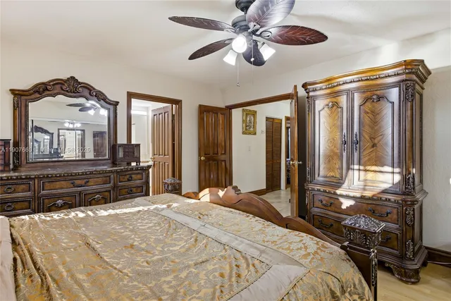 a bedroom with a bed and a large mirror with a flat tv screen