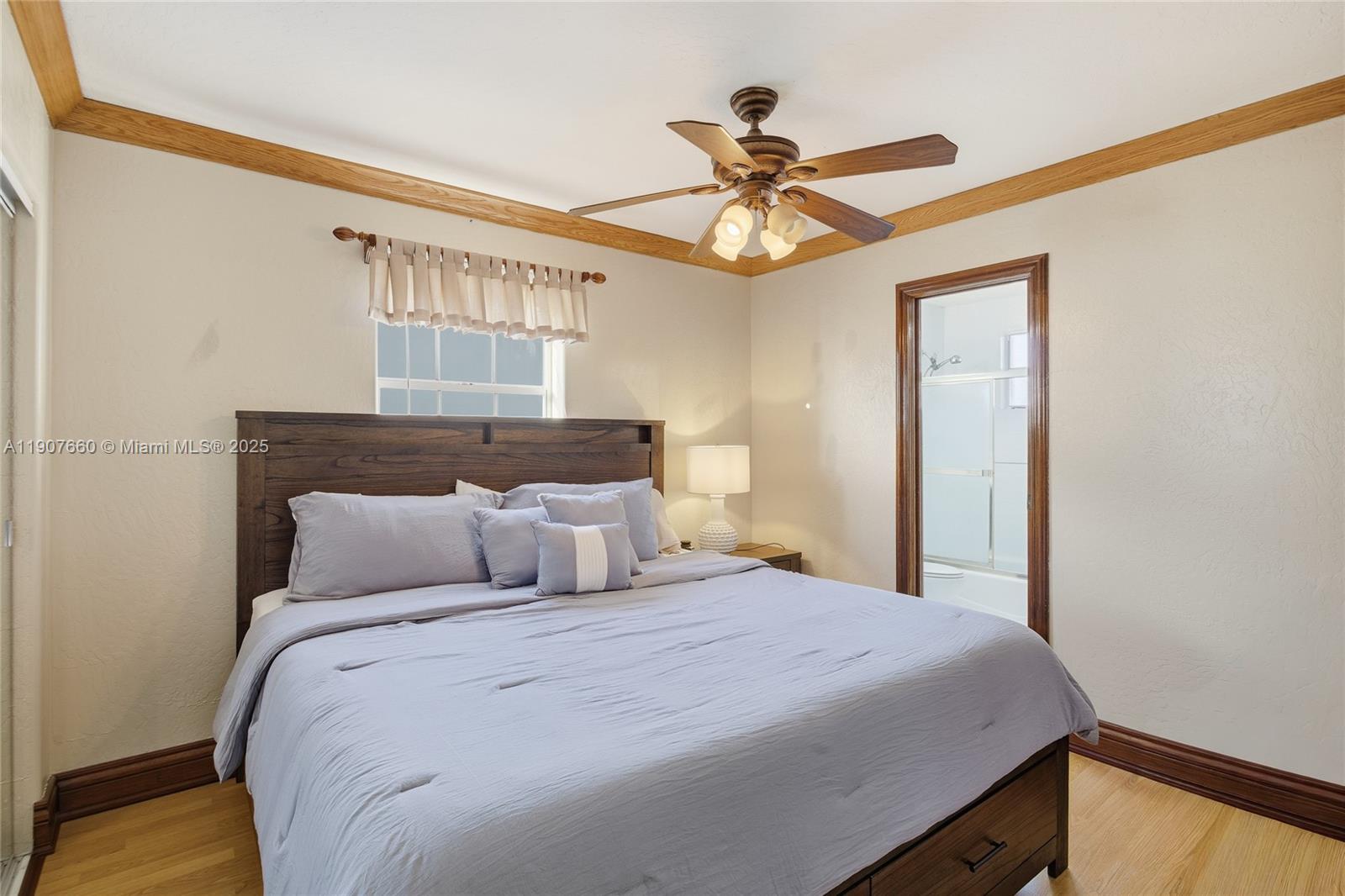 20816 Southwest 85th Place Cutler Bay, FL 33189 - Photo 36 of 49 a bedroom with a large bed and a chandelier