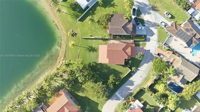 an aerial view of a house with a yard