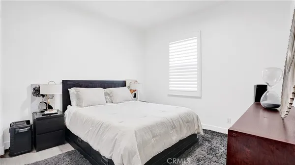 a bedroom with a bed and a desk