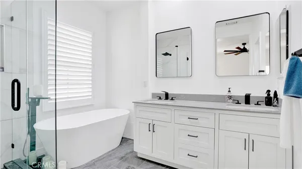 a bathroom with a tub sink and a mirror
