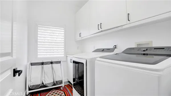 a view of a white house with a yard