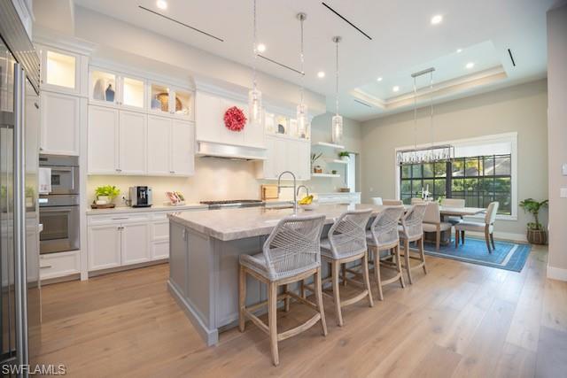Undisclosed Address Naples, FL 34110 - Photo 5 of 18 a kitchen with a dining table chairs wooden floor cabinets appliances and a window