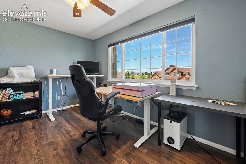 10643 Pictured Rocks Drive Peyton, CO 80831 - Photo 21 of 37 a workspace with furniture and wooden floor