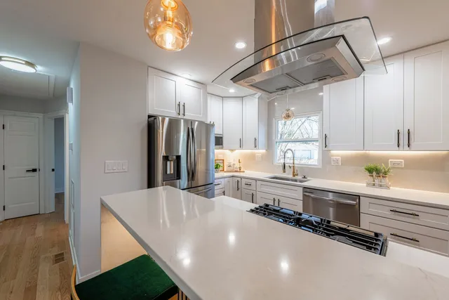a kitchen with a sink stove and cabinets