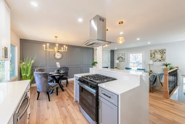 a bathroom with a sink a toilet a mirror a vanity and shower