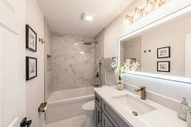 a bathroom with a sink a toilet and a bathtub