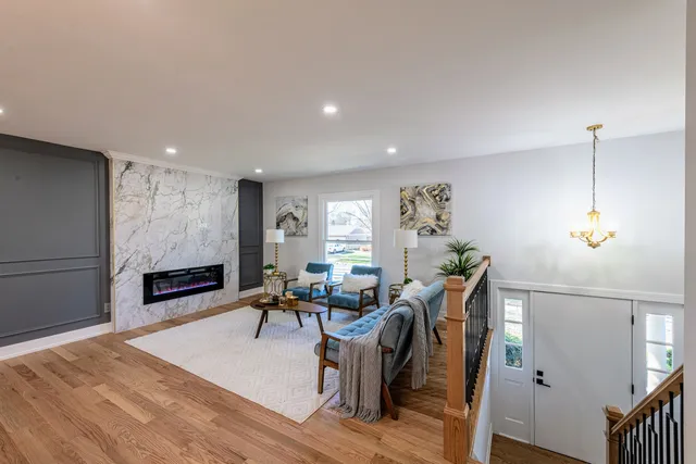 a living room with furniture a window and a flat screen tv