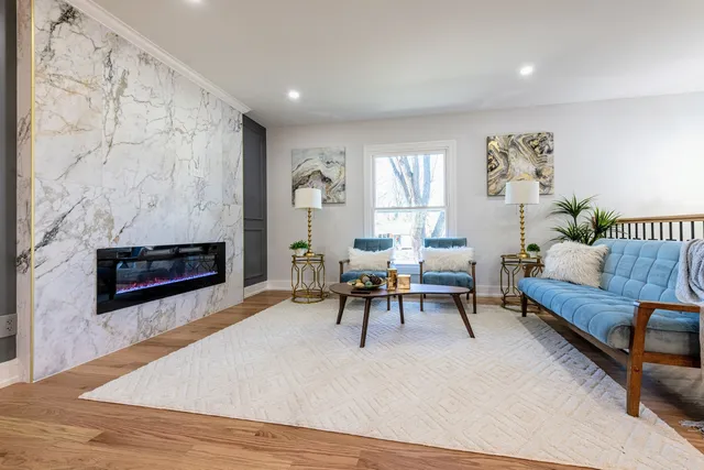 a living room with furniture and a fireplace