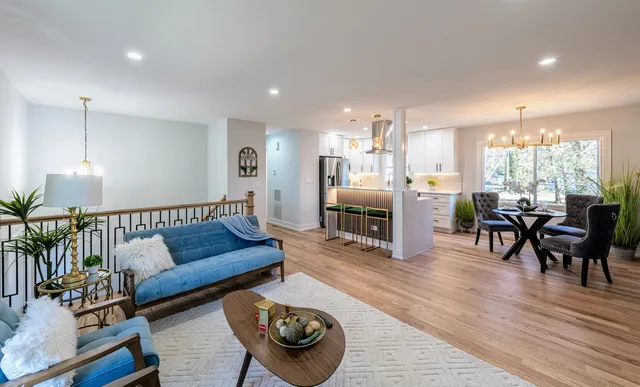 a living room with furniture and wooden floor