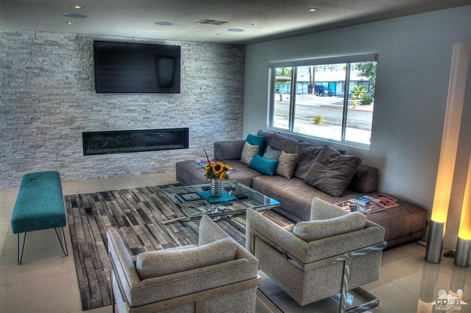 465 East Simms Road Palm Springs, CA 92262 - Photo 13 of 41 a living room with furniture a flat screen tv and a fireplace