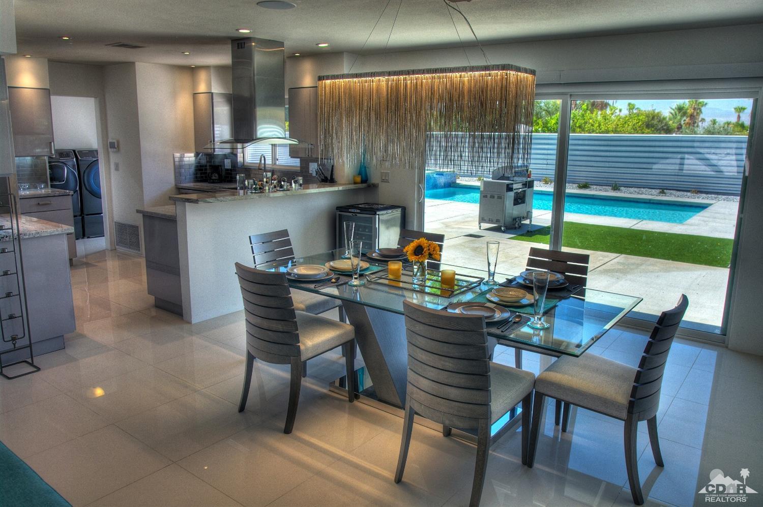 465 East Simms Road Palm Springs, CA 92262 - Photo 16 of 41 a dining area with a table chairs and a kitchen view