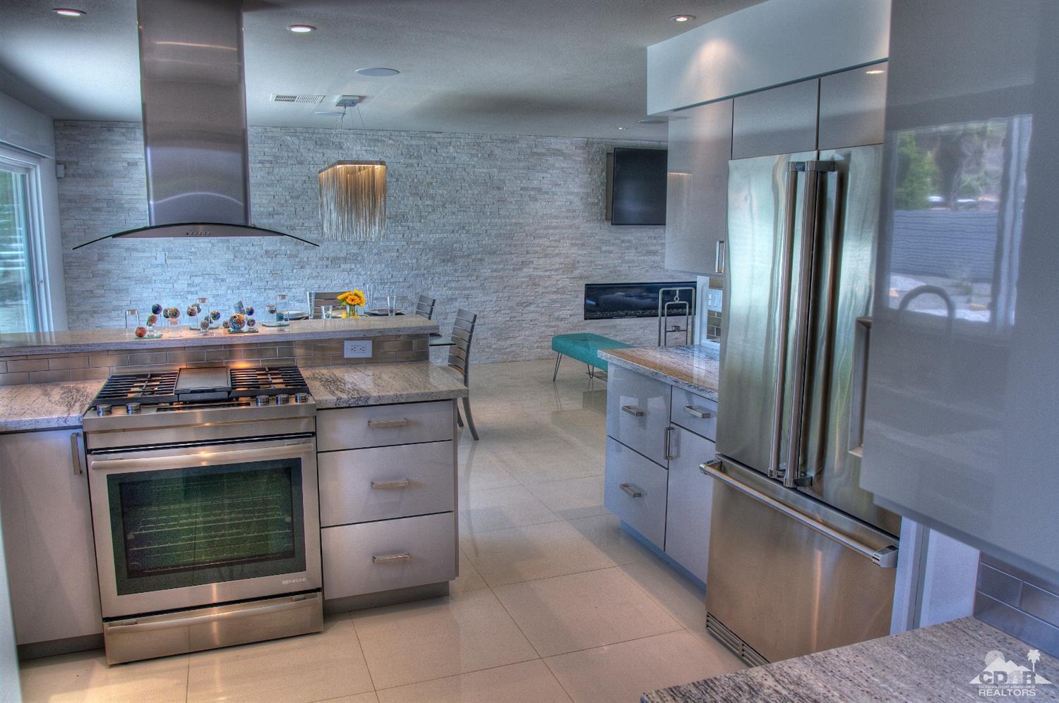 465 East Simms Road Palm Springs, CA 92262 - Photo 20 of 41 a kitchen with stainless steel appliances granite countertop a stove and a refrigerator