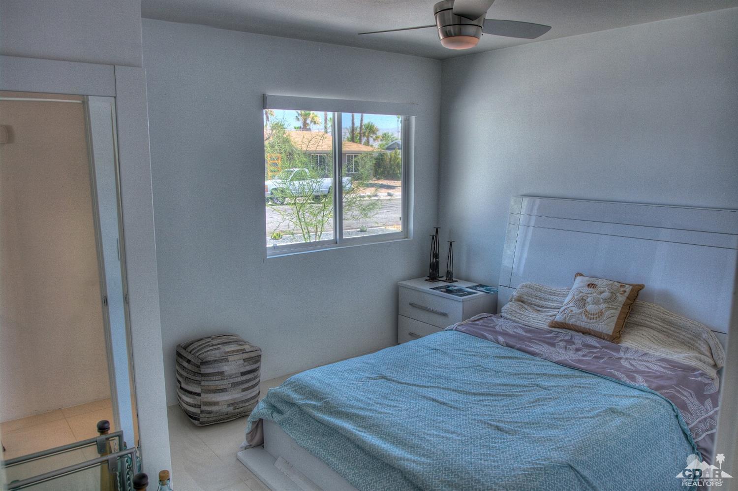 465 East Simms Road Palm Springs, CA 92262 - Photo 21 of 41 a bedroom with a bed and a window