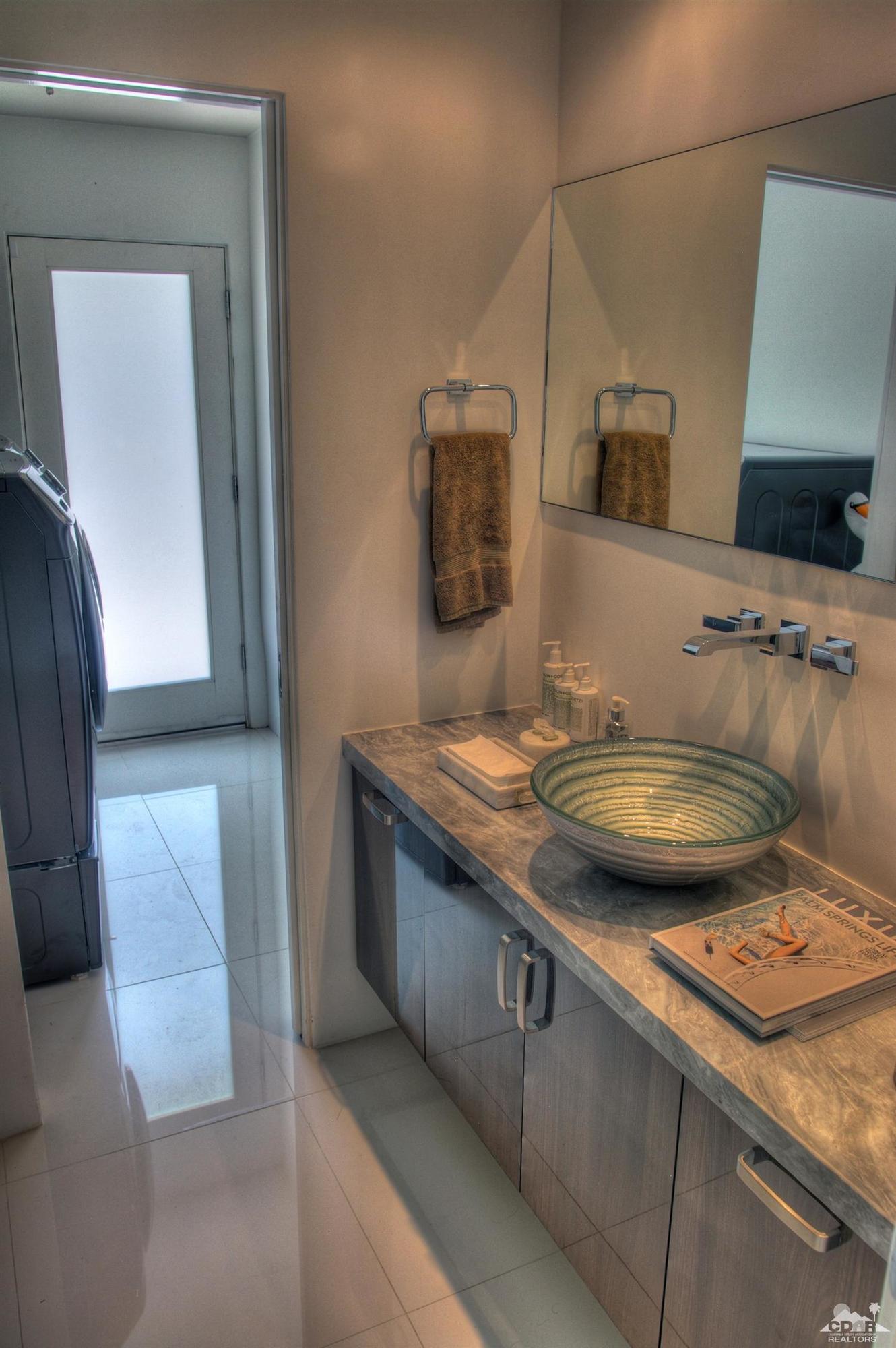 465 East Simms Road Palm Springs, CA 92262 - Photo 23 of 41 a bathroom with a granite countertop sink a mirror and vanity