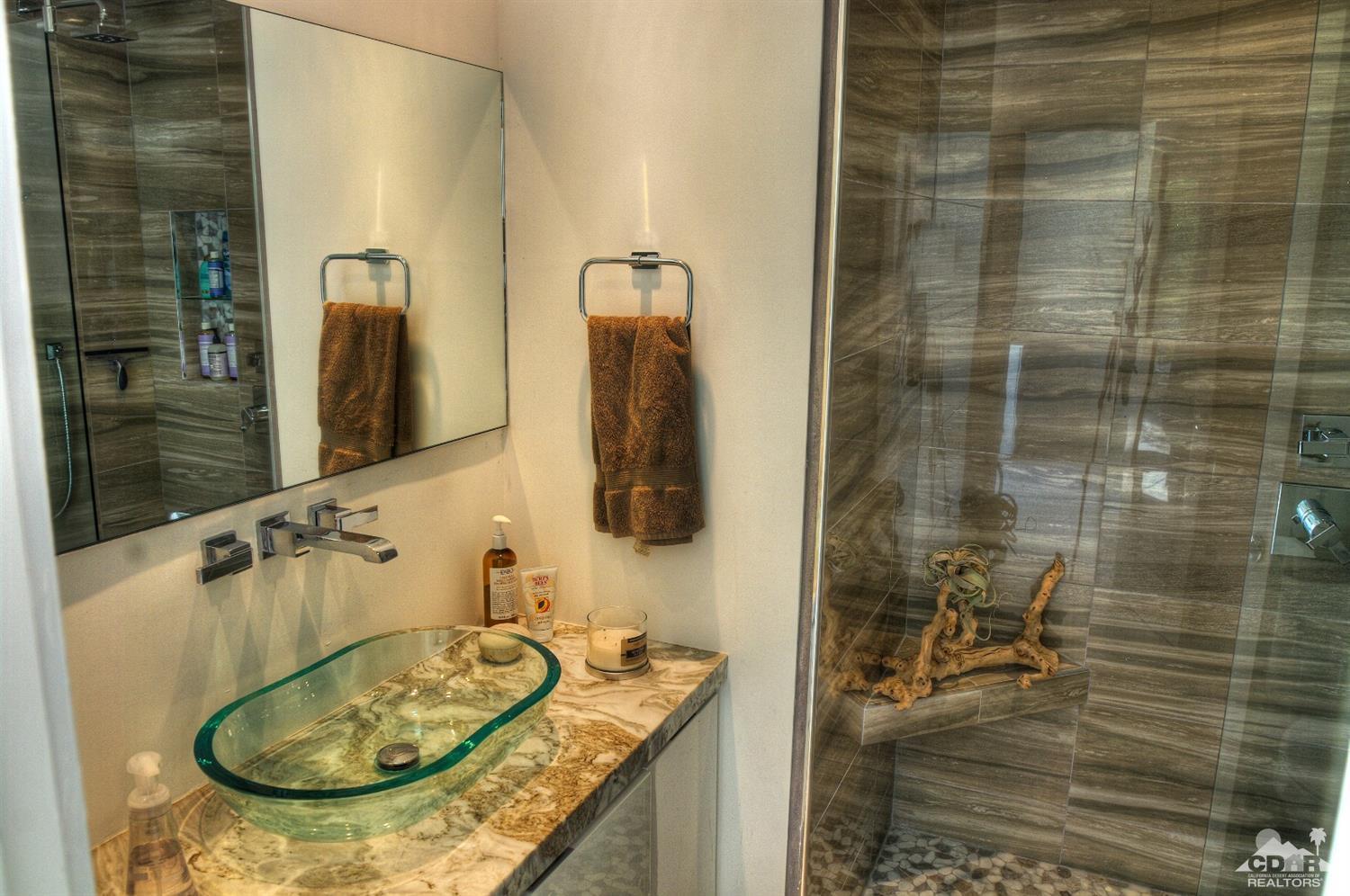 465 East Simms Road Palm Springs, CA 92262 - Photo 28 of 41 a bathroom with a granite countertop sink a mirror and shower