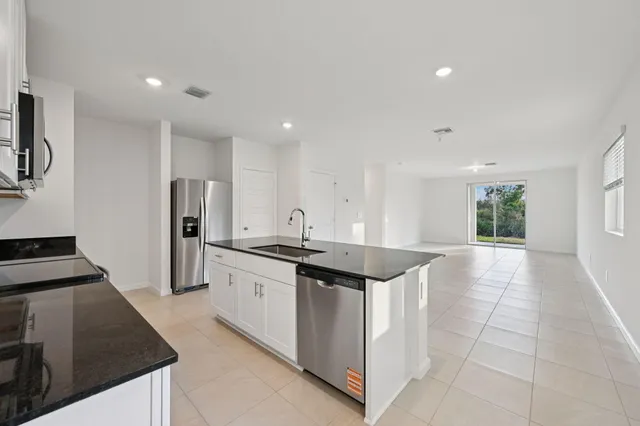 a kitchen with stainless steel appliances granite countertop a sink and a stove