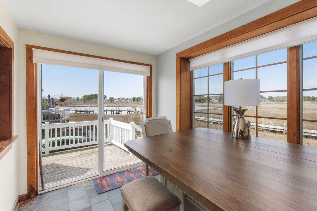 14 Lower County Road Dennis Port, MA 02639 - Photo 13 of 56 a view of a living room and floor to ceiling window with wooden floor