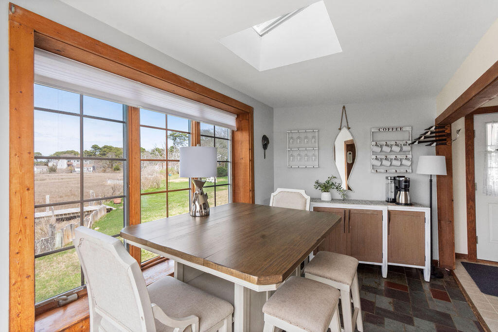 14 Lower County Road Dennis Port, MA 02639 - Photo 15 of 56 a dining room with furniture and a floor to ceiling window