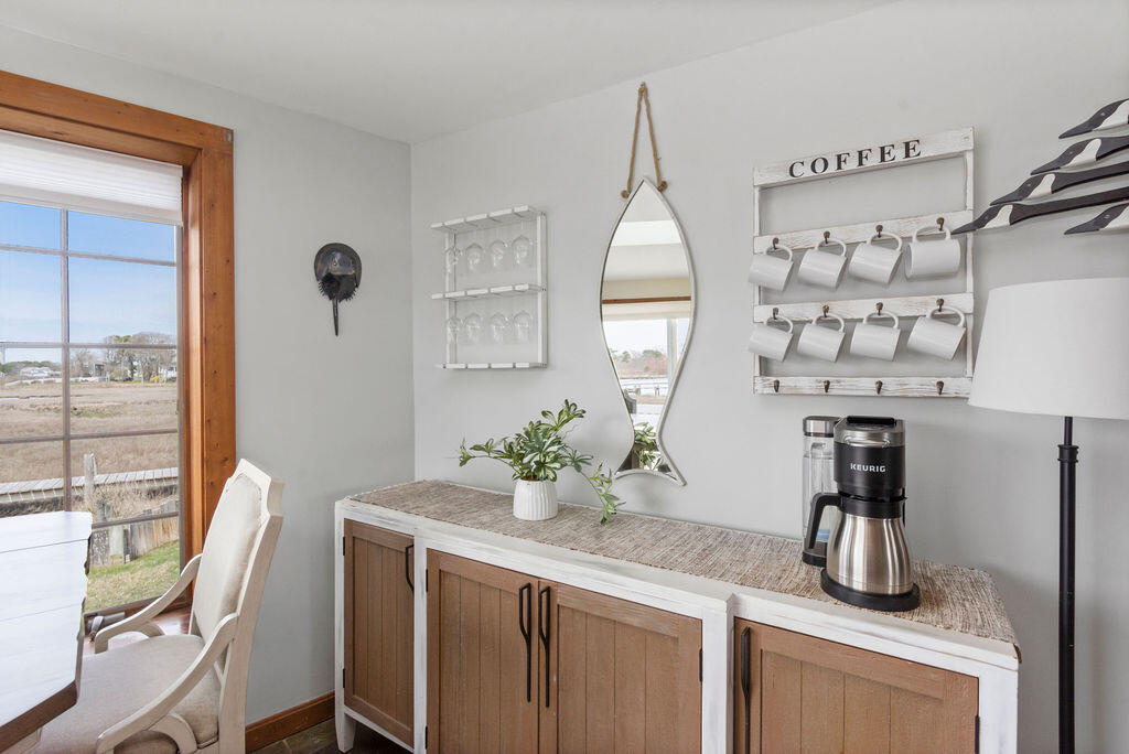 14 Lower County Road Dennis Port, MA 02639 - Photo 17 of 56 a kitchen with a table and chairs in it