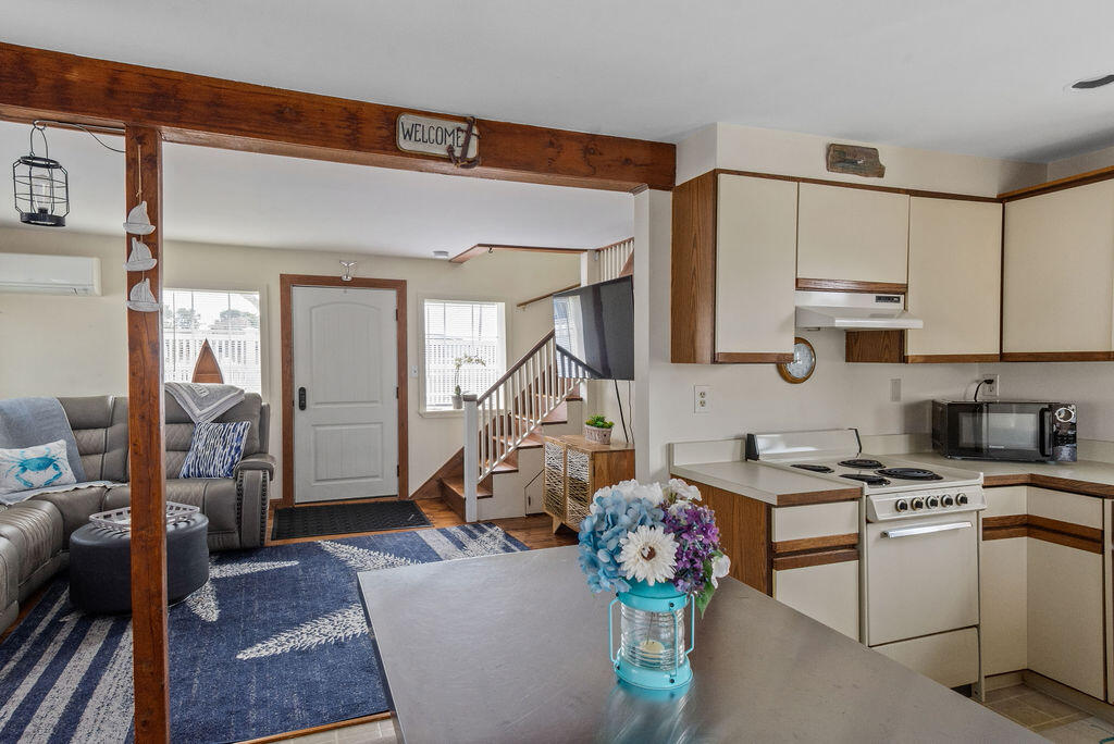 14 Lower County Road Dennis Port, MA 02639 - Photo 21 of 56 a kitchen that has a lot of white cabinets and stainless steel appliances